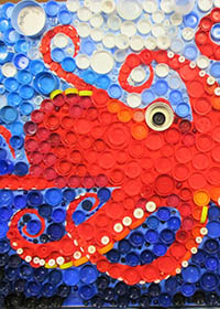 red octopus in the sea, made from plastic bottle tops