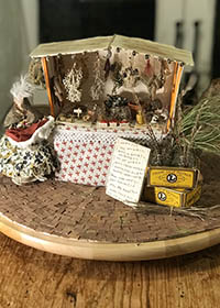 miniature model of a market stall with herbs hanging down