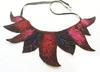 Textile necklace. Red, pink and purple fleece, moulded into feathers.