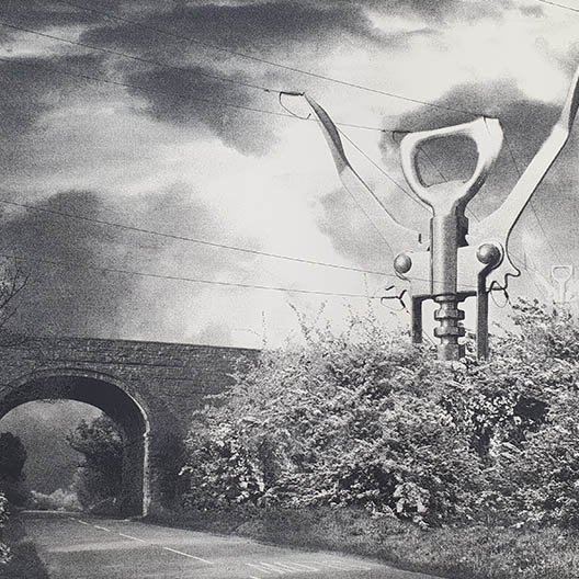 old fashioned photograph of a bridge with electricity lines held by pylons made from bottle openers